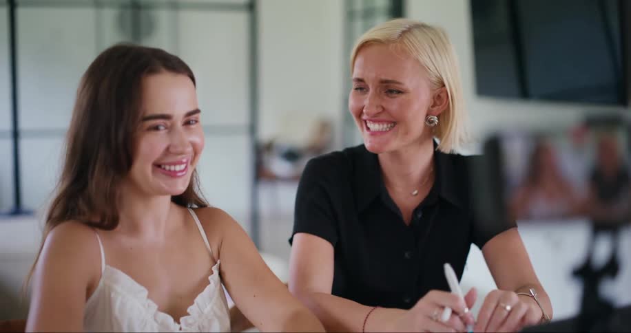 Iphone recording two women sitting at a table smiling