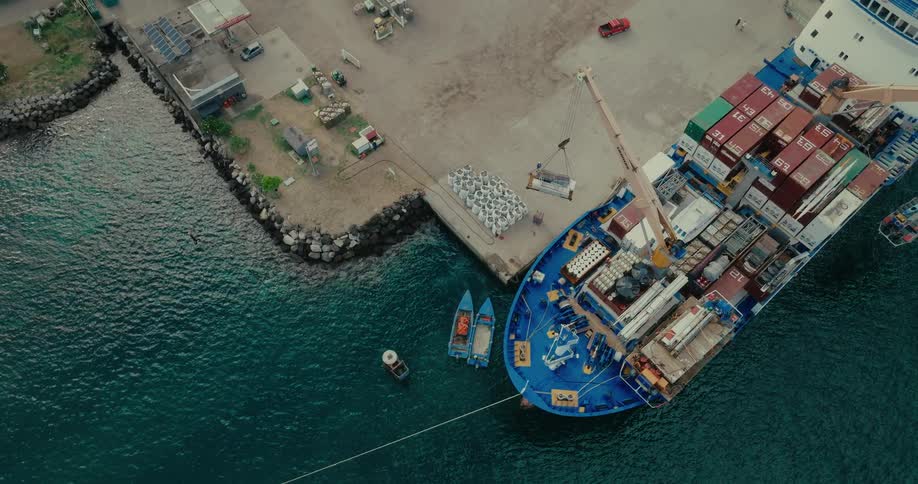 Aerial view of a ship in a port removing containers