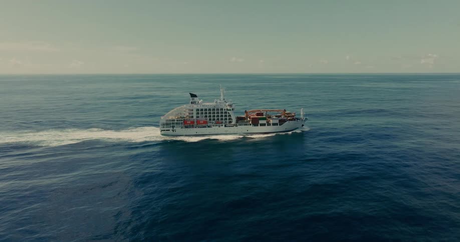 Passenger ship and cargo ship traveling at sea