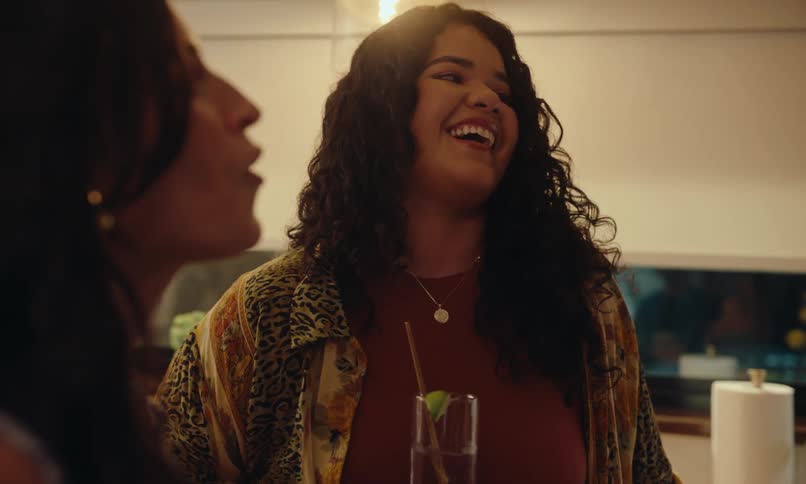 Friends have drinks and talk at a party