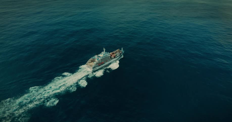 Aerial view of a container ship moving through the sea