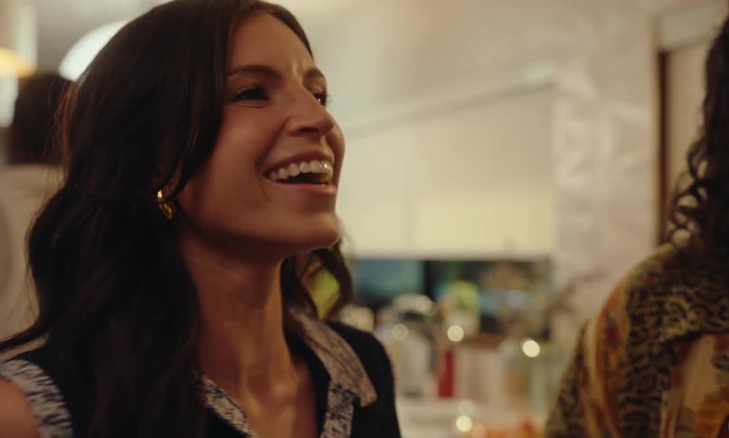 A woman talks and laughs at a party