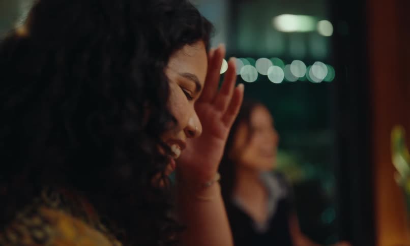 Women sitting at a table in a moment of celebration chatting happily