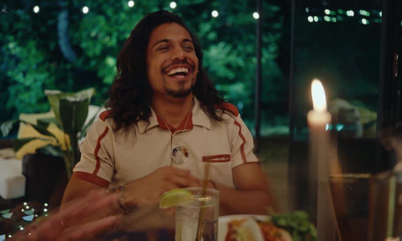 Friends talk and laugh at dinner