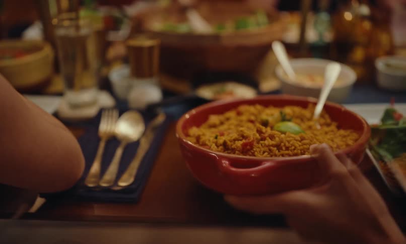 Some people gathered around a table full of food