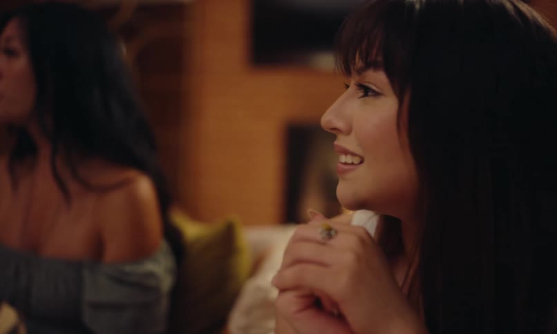 Portrait of a woman sitting and talking to other people