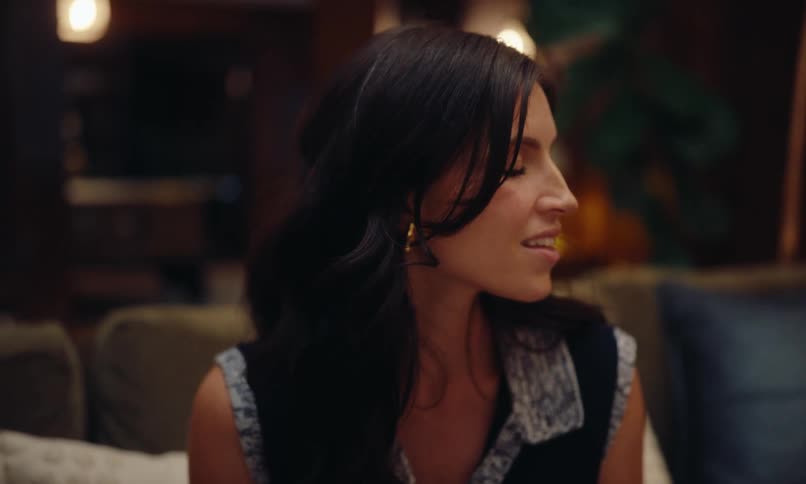 A woman is looking intently to the left and she is moving her head subtly up and down in agreement tones