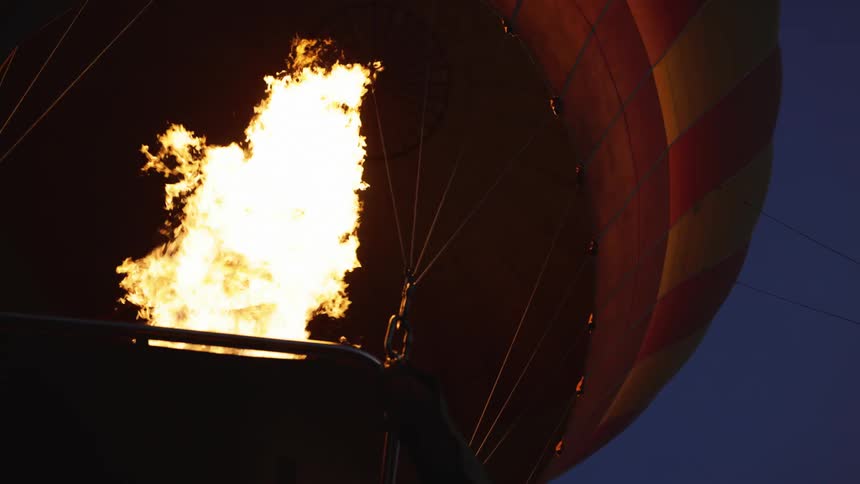 Flame rising in a large balloon at night