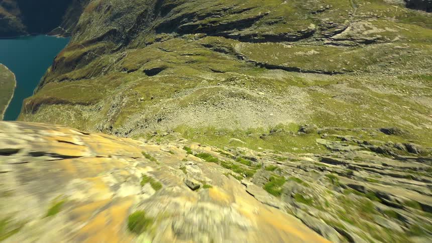 Aerial panorama of a mountain valley with a lake in the background