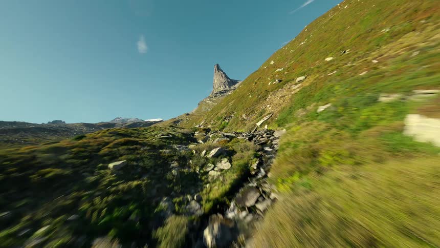 Aerial landscape of a winding river with rocks in a mountain valley