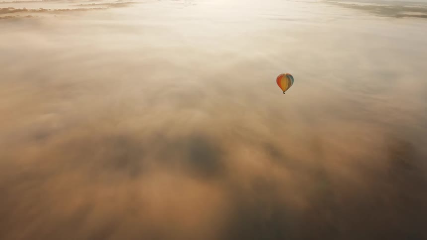 A hot air balloon travels high in the sky