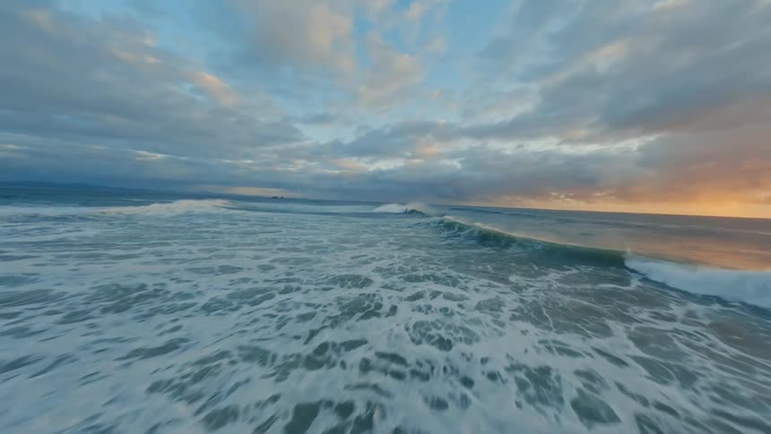 The sun is rising on the ocean