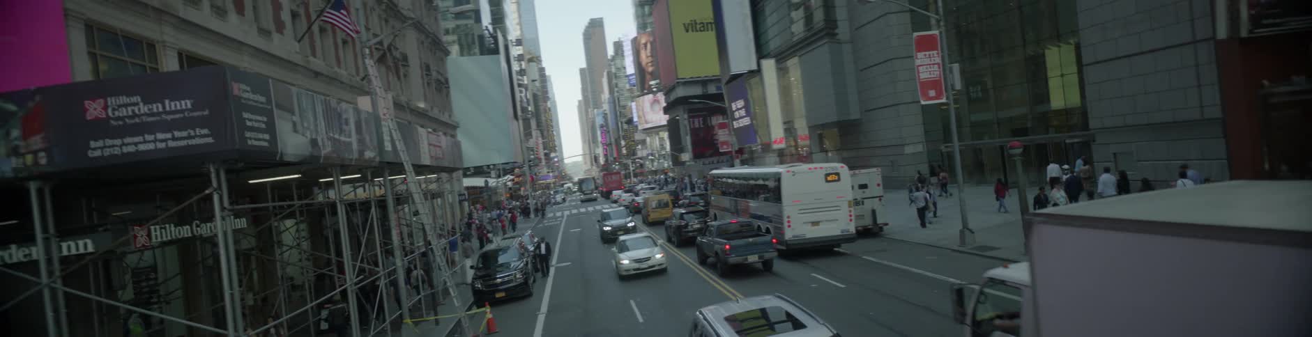 Vehicles pass down a busy city street