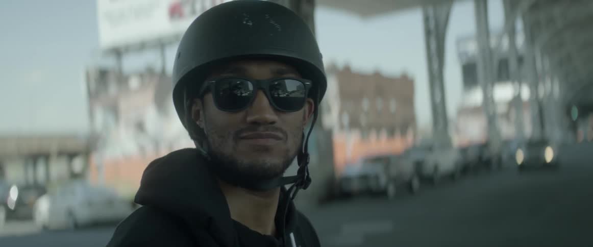 A close up shot of a biker smiling with his helmet on
