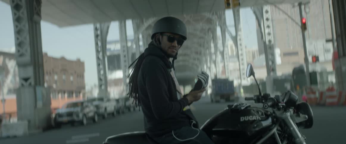 A motorcyclist fastens his glove