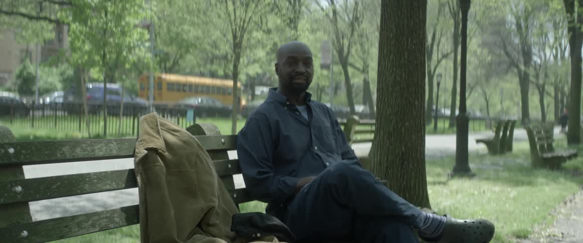 A man sitting on a park bench in the daytime