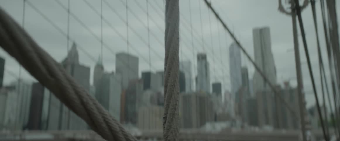 A bridge with lots of wires on a cloudy day