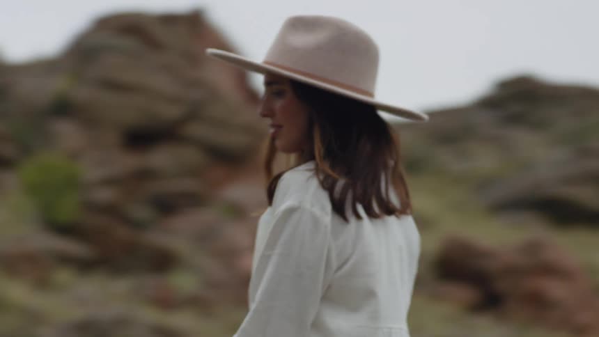 Cowgirl riding a horse in a valley