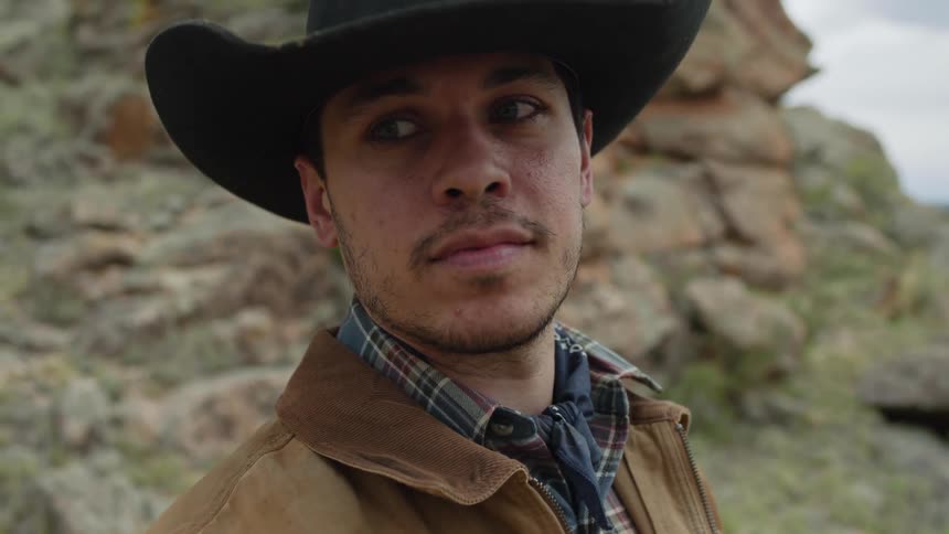 Portrait of a man wearing a black hat in a natural setting