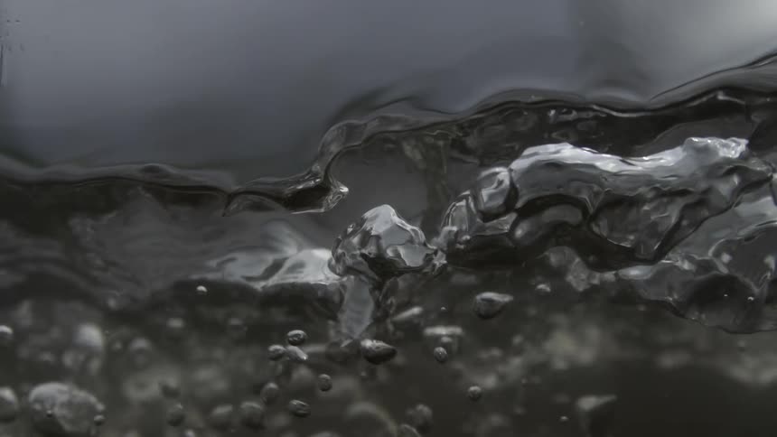 Extreme close up of water with moving air bubbles