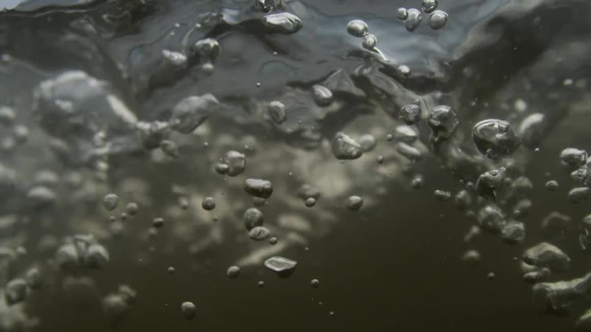 Closeup of moving water with lots of bubbles