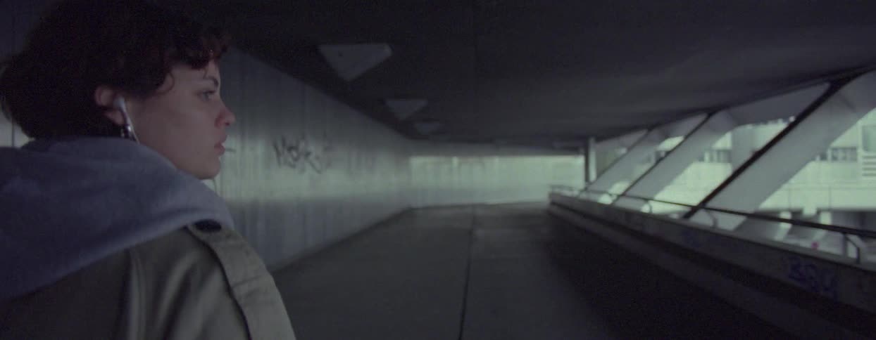 Woman walking down a hallway and looking around