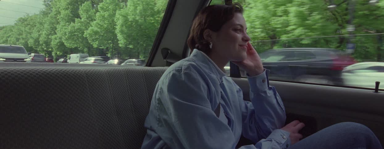 A woman looks out the window while riding in the car