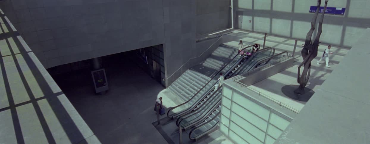People going up and down stairs inside a building
