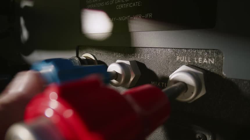 Finger clicking buttons on an airplane