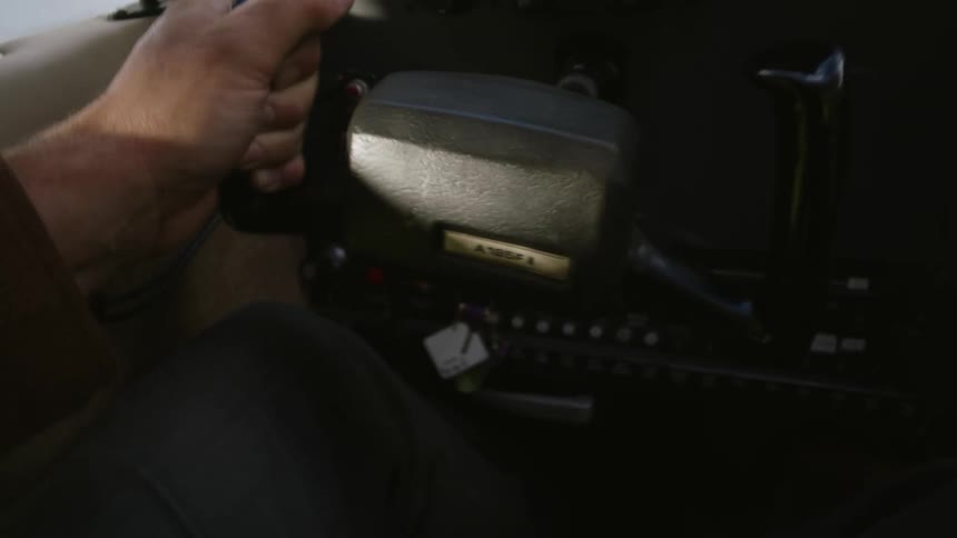 Hand of a person piloting an airplane