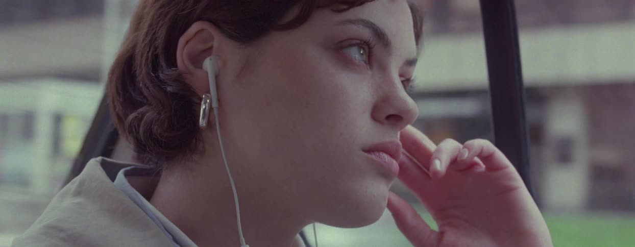Woman with her hand on her face while inside a moving vehicle