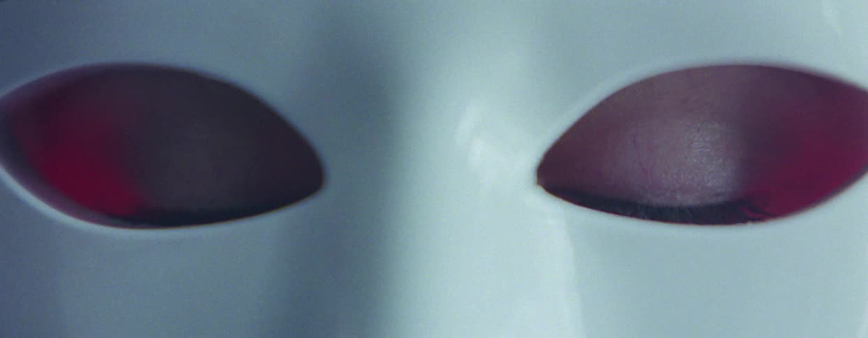 Extreme close up of a womans eye opening in a mask