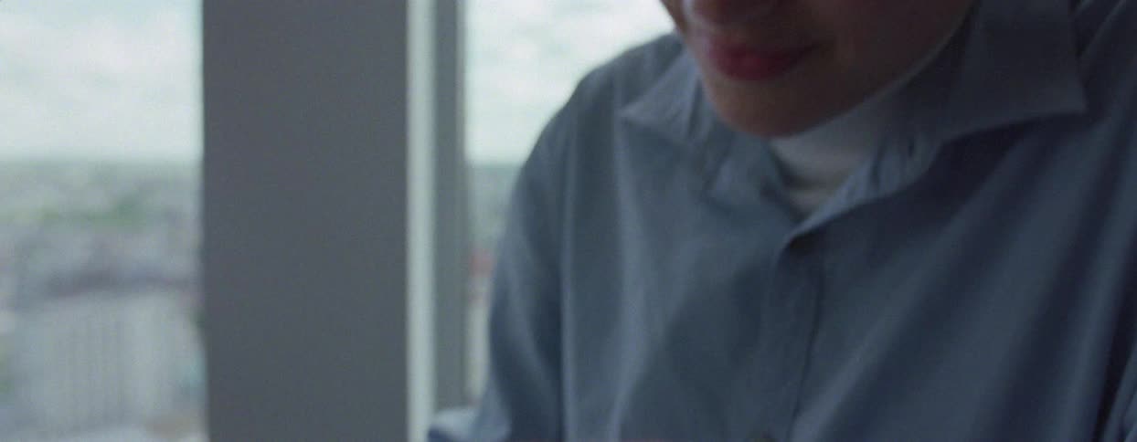 Woman sitting at a table writing a letter