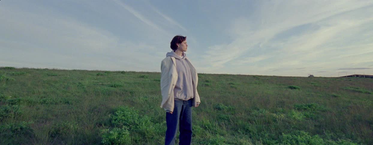 Woman walking through a vast field
