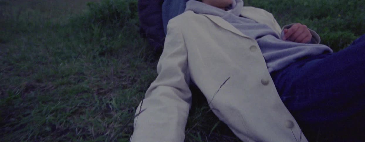A woman lays in the grass