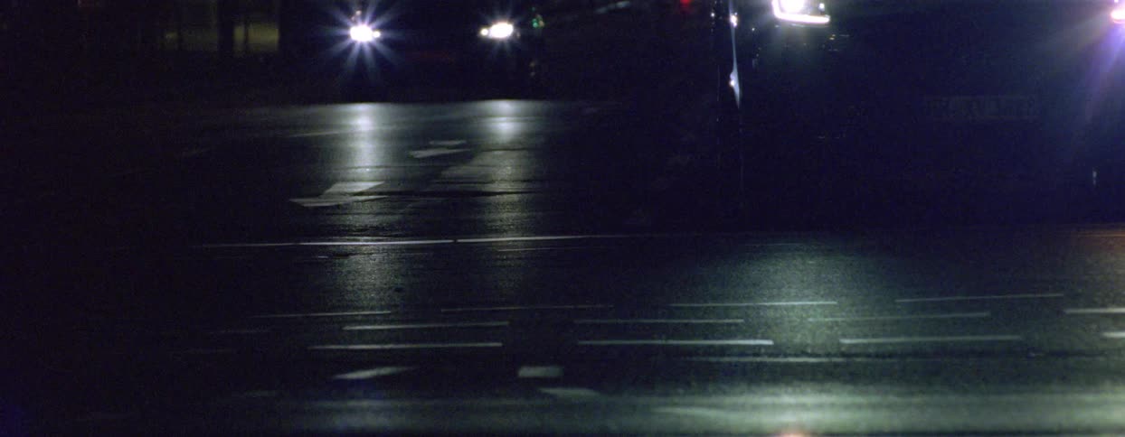 Heavy traffic crosses a road while cars traveling perpendicularly wait at the intersection