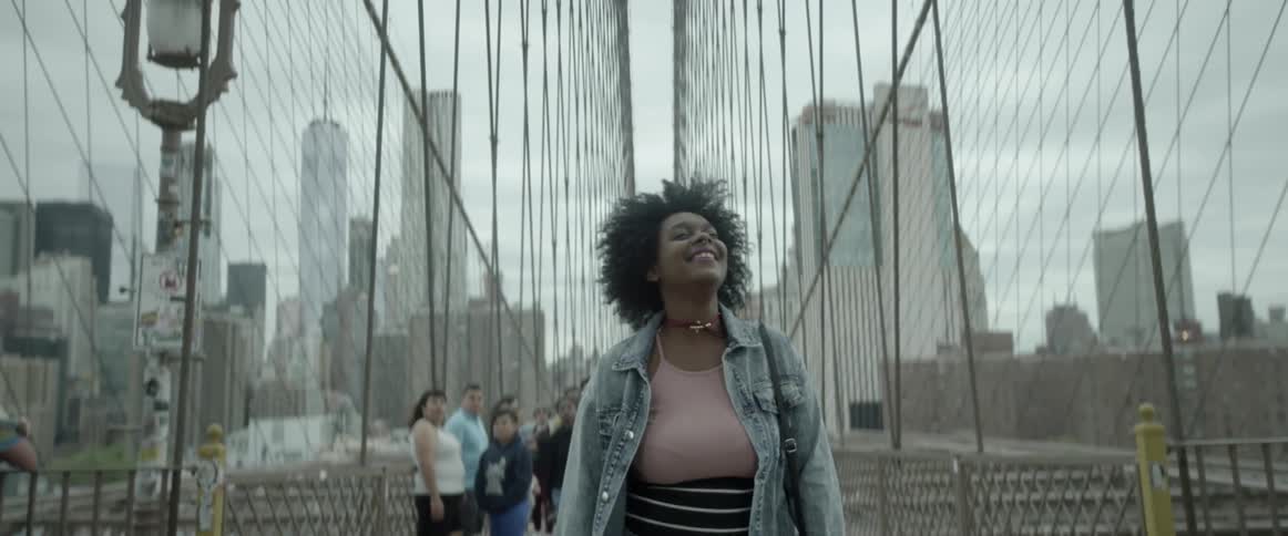 A woman in a striped skirt looks up and around