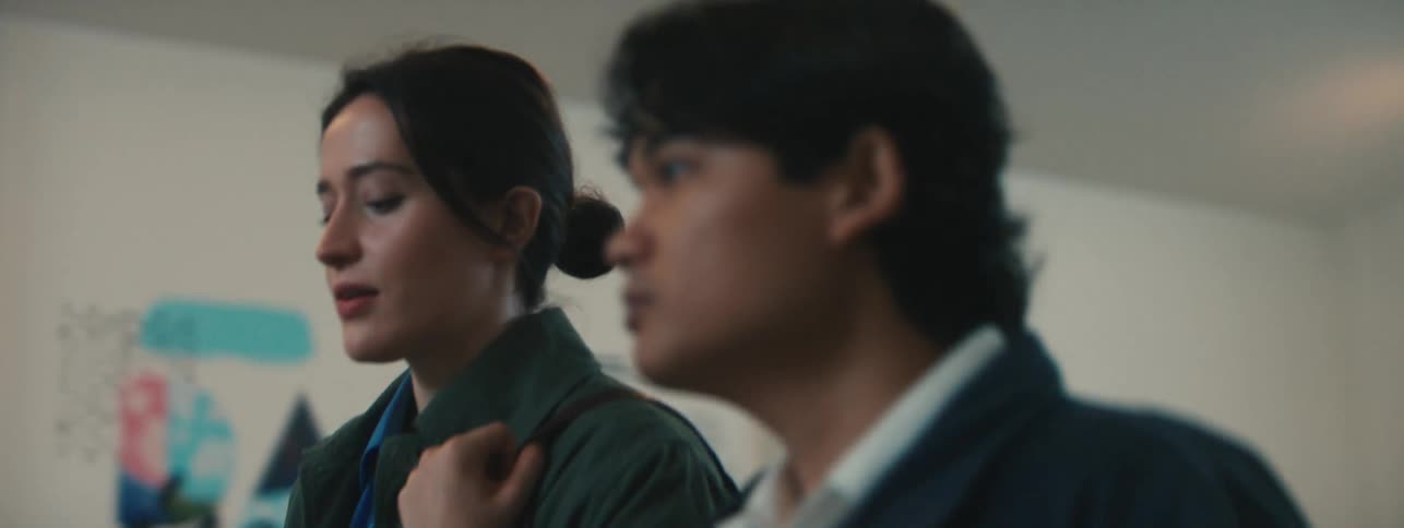 Woman and a man walking together talking inside a building