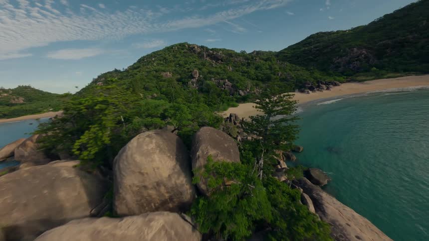 Aerial View of a Secluded Island with Two Pristine, Empty Beaches Surrounded by Lush Greenery and Crystal-Clear Waters
