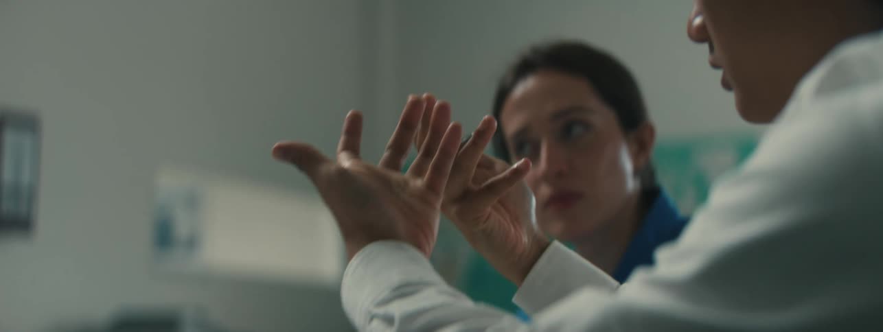 Concentrated woman watching a mans hands