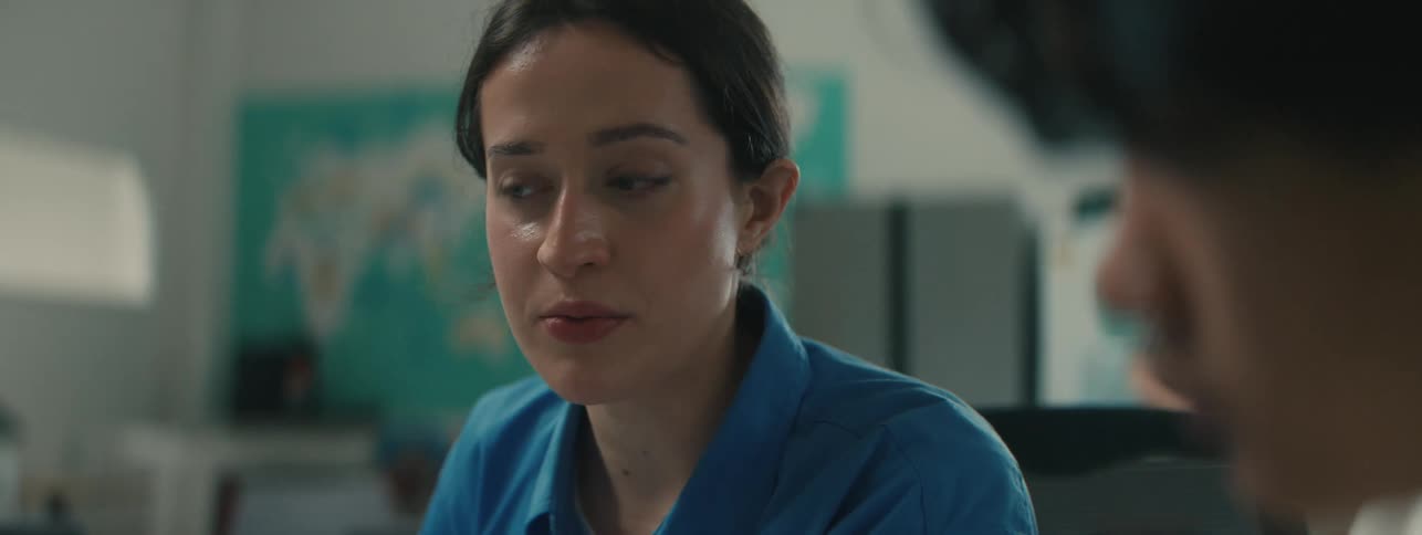 A woman with a prosthesis for her arm uses a tablet and stylus to explain something to another person