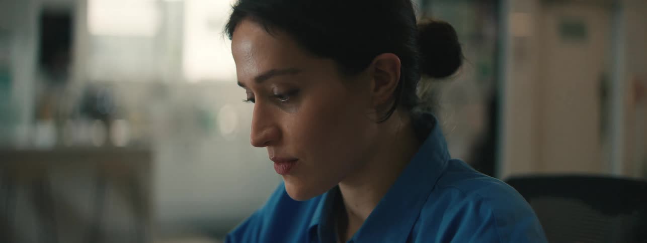 Close up of the face of a smiling woman wearing a blue top
