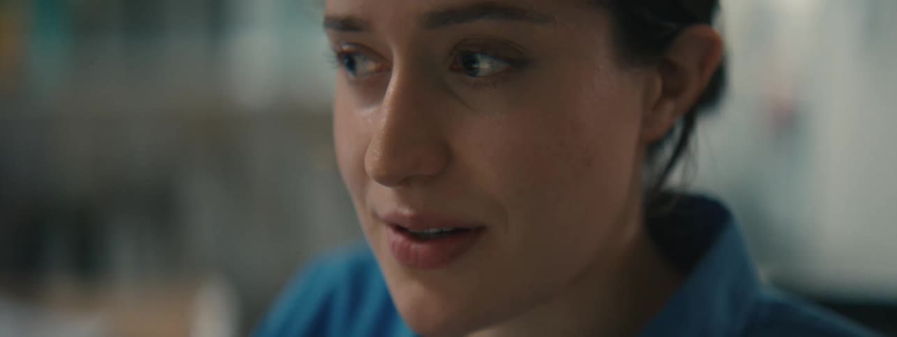 A contemplative woman smiles and nods to herself