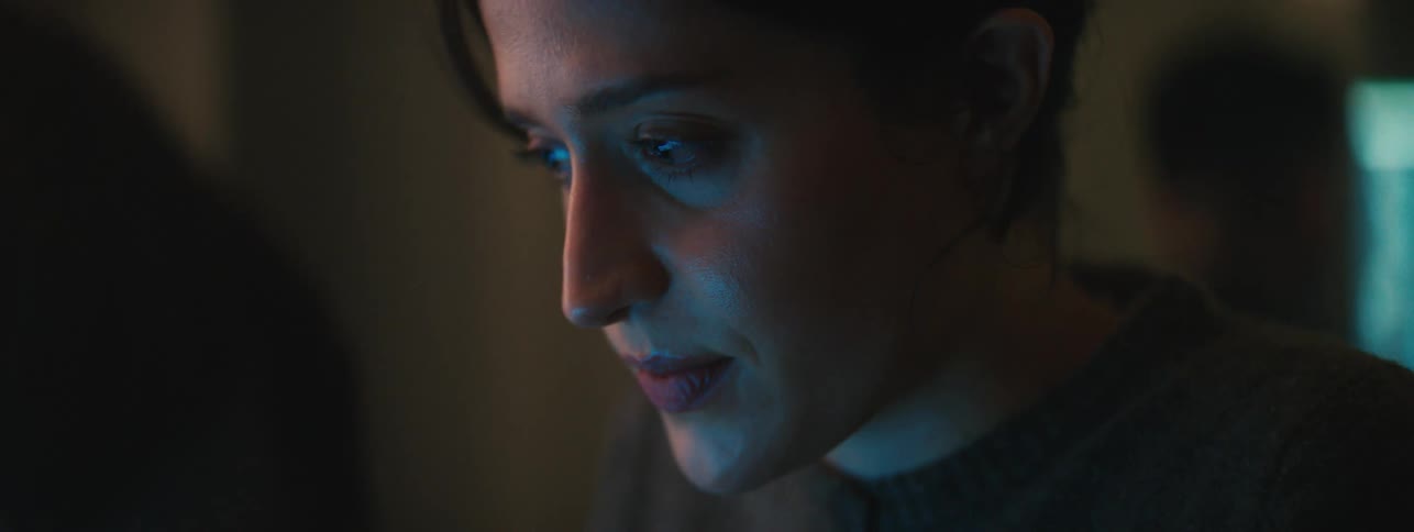 Portrait of a young woman concentrating in a lowlit room