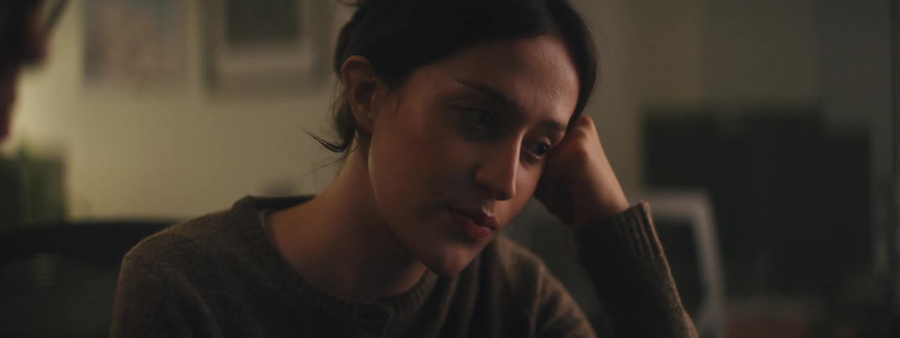A woman sitting next to a man appears tired but contemplative