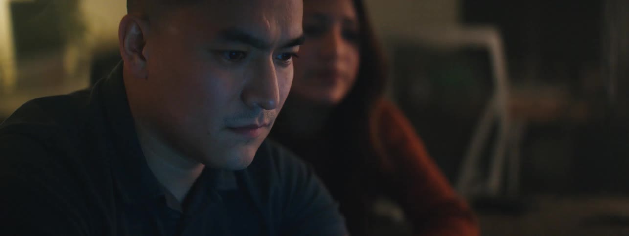 Man next to a woman concentrating