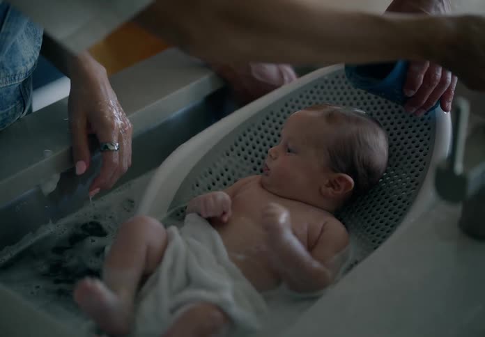 Baby taking a bath in the sink