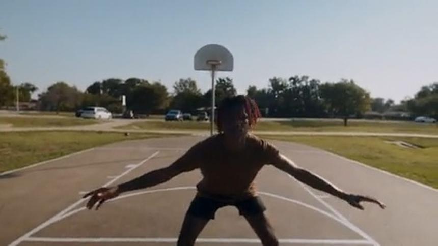 Point of view of a person pulling on hands helping to stand up while they are on an outdoor court playing basketball