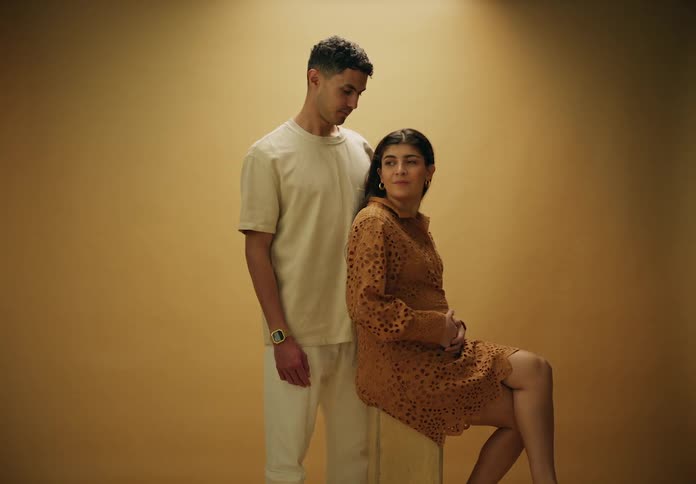 A man and a woman touch each other and look affectionate with one another