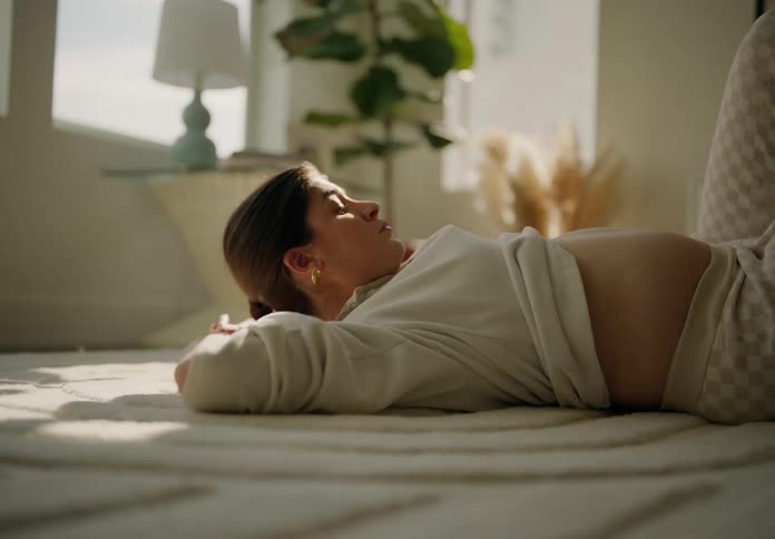 Pregnant woman does crunches in her living room